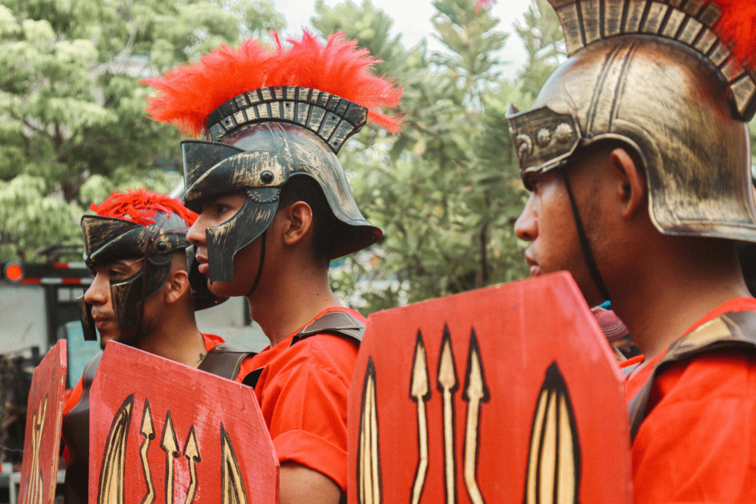 Men dressed as Roman warriors in a lively outdoor parade.