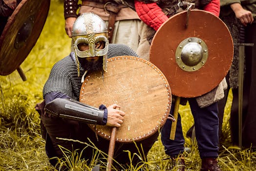 Medieval warriors in armor at a reenactment event, showcasing shields and helmets.